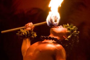 Fire knife dancer performing at a commercial luau.