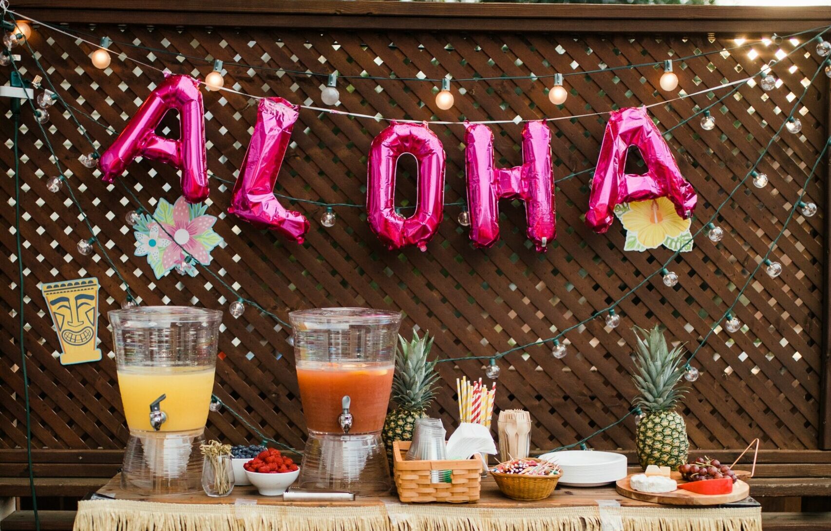 Balloons spell out the word 'Aloha" at a backyard luau