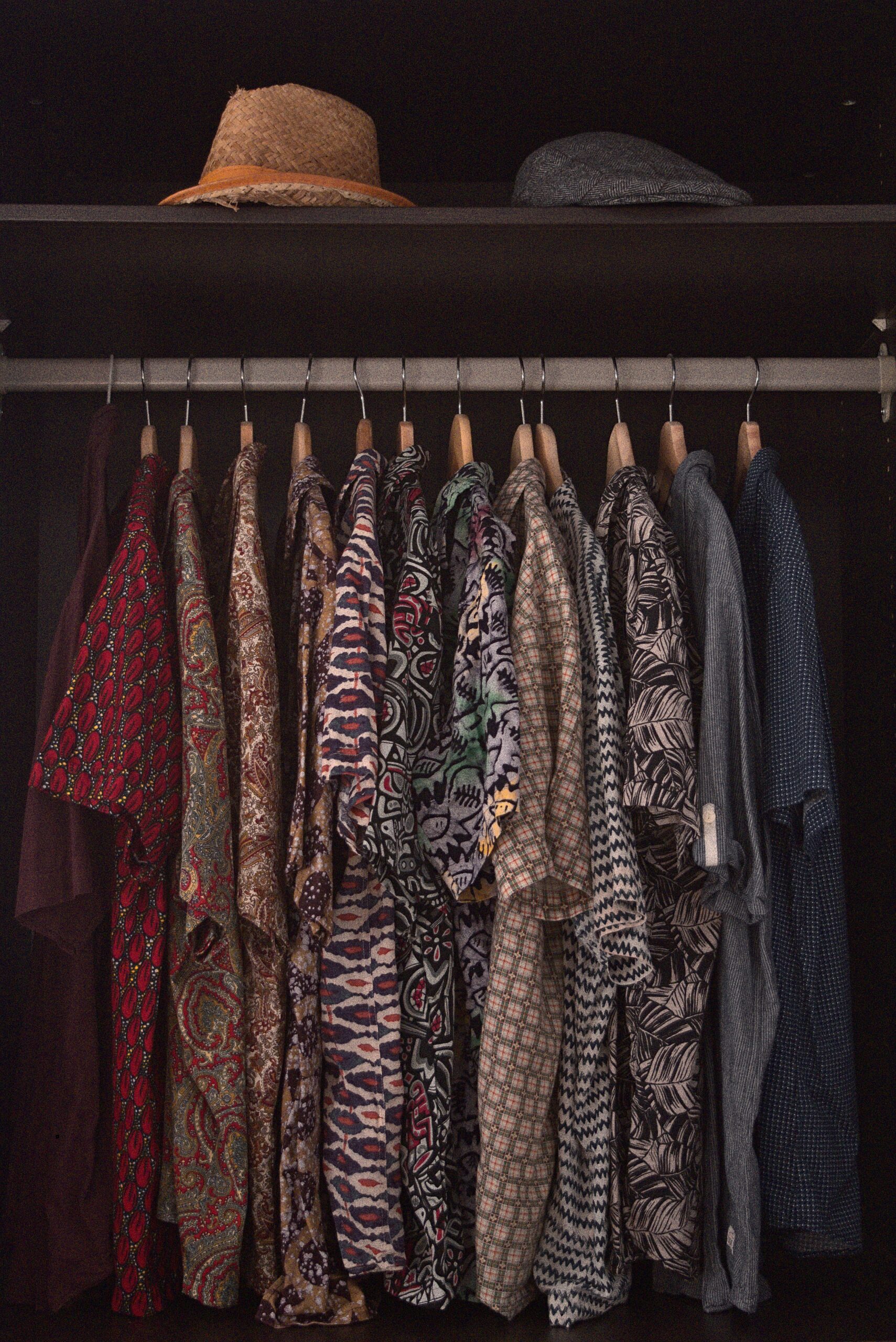 Closet of Aloha shirts in a muted color palette.