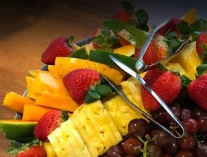 fresh fruit platter with pineapple, strawberries, and grapes.