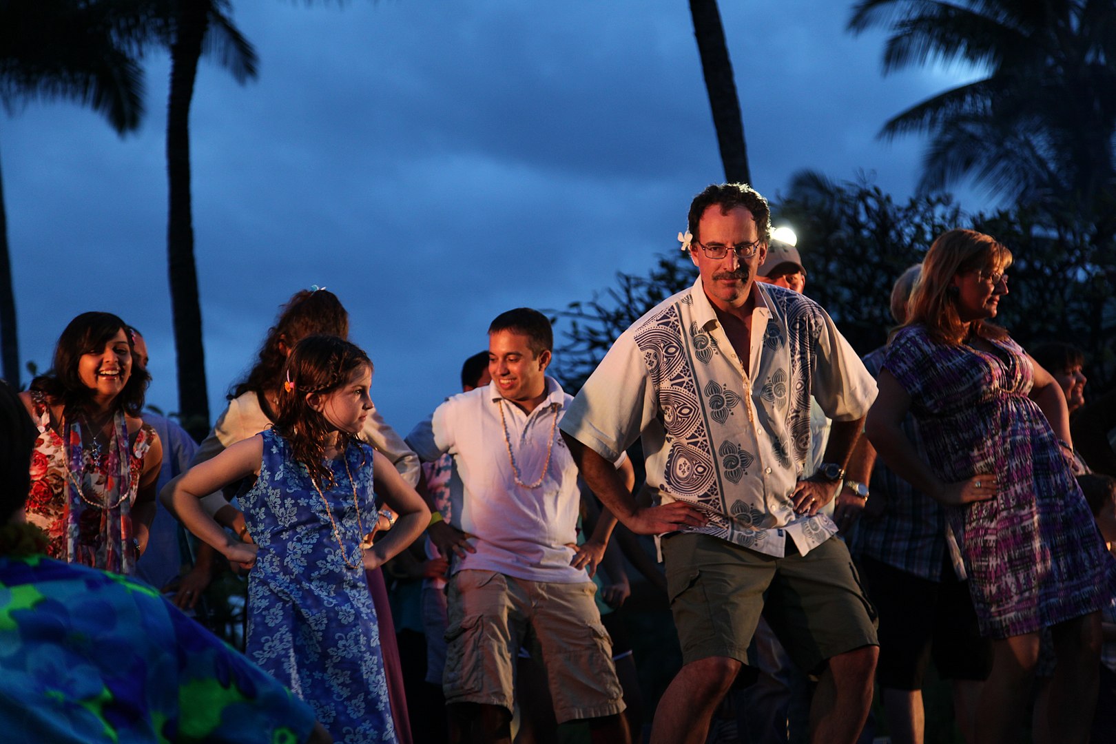 Guests learning how to hula at a Hawaiian Luau.