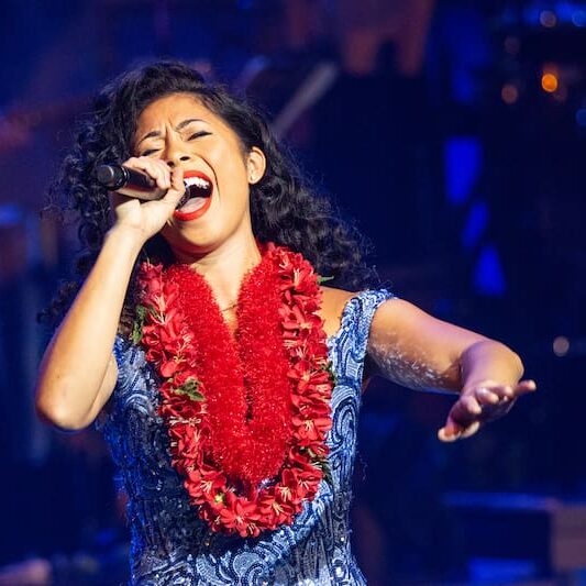 Local recording artist Meleana Brown sings onstage at the Rock A Hula show in Waikiki.