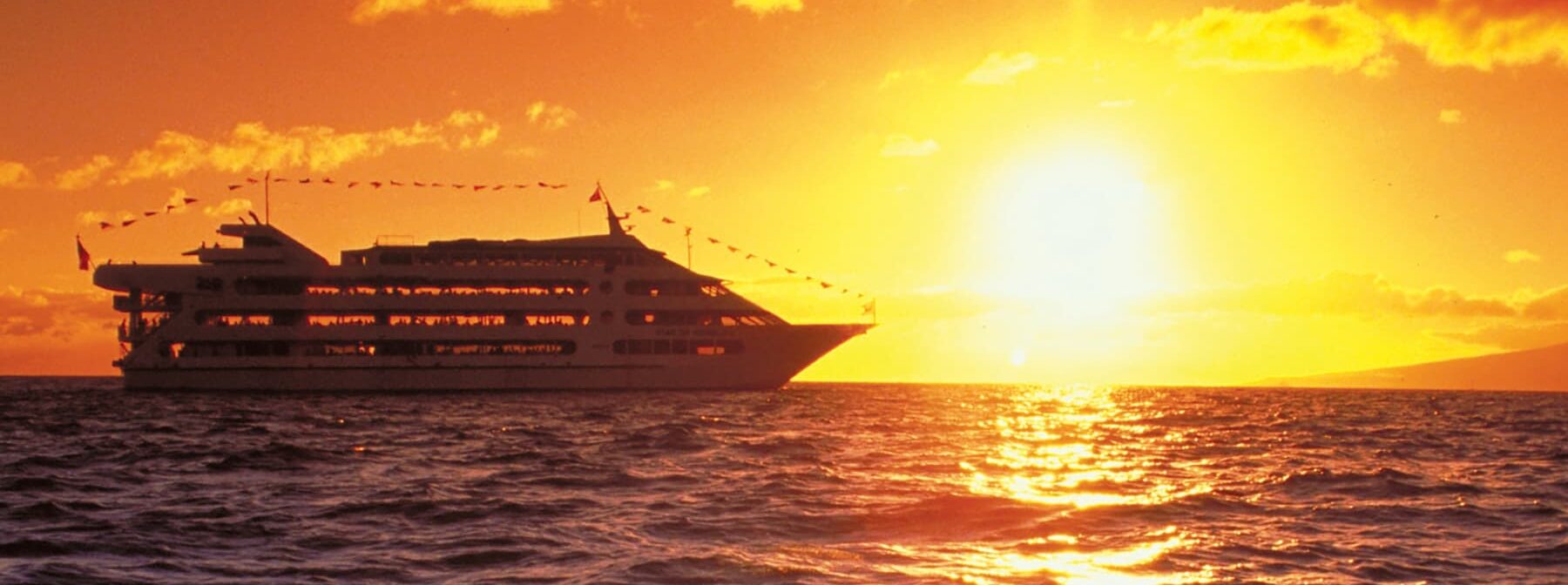 The Star of Honolulu dinner cruise with sunset in the background