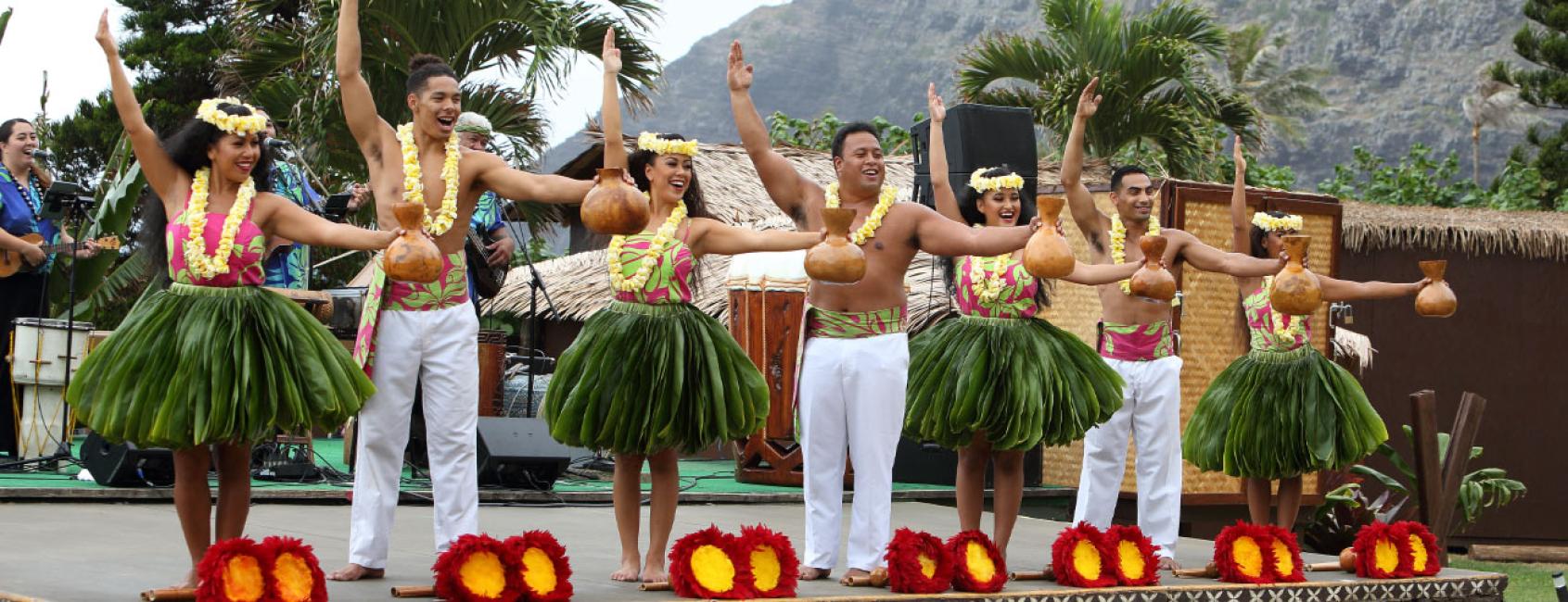 Performers in traditional Hawaiian dress line the stage at the Aloha Kai Luau on Oahu's East Side.