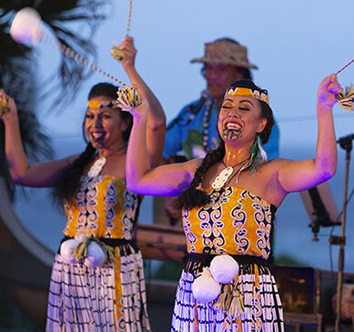 Hula dancer twirl poi balls at Aloha Kai Luau, Oahu.