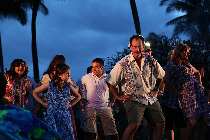 Luau audience member learn to dance the hula. 
