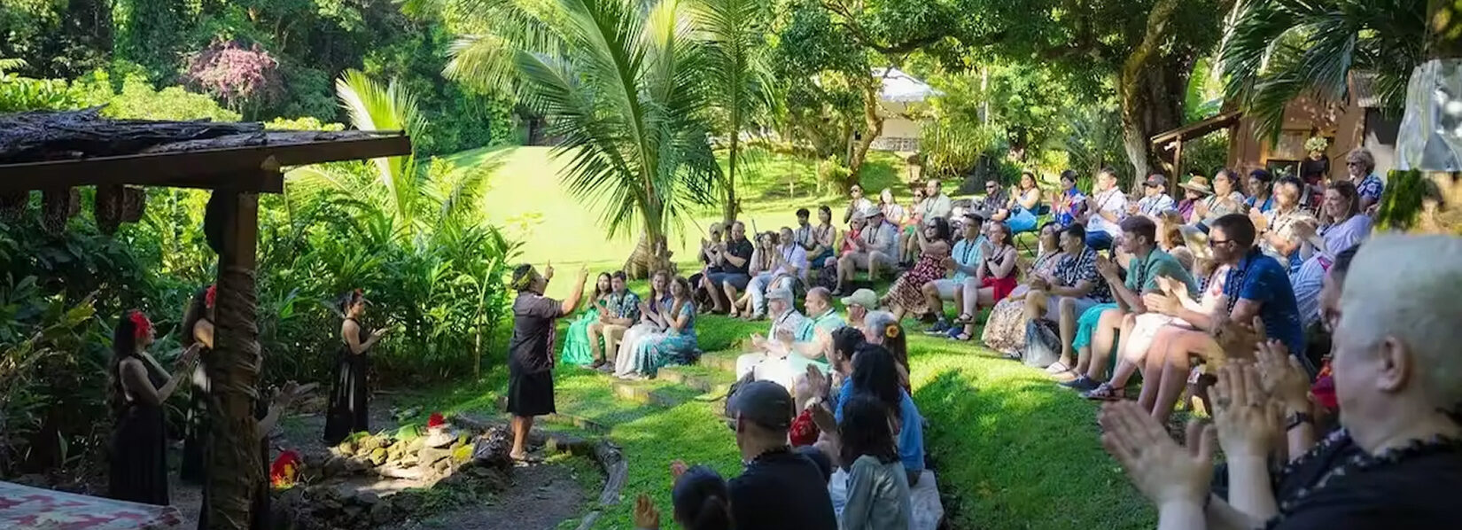 Guests are seated for a cultural demonstration at Nutridge Luau on Oahu.