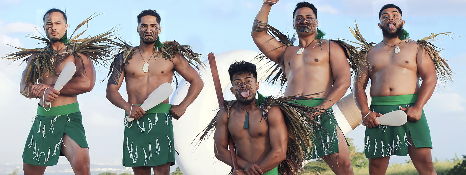 Mauka Warrior Luau cast members pose on stage looking ready for battle.