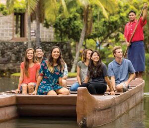 Canoe Passengers ride to a new island village at the Polynesian Cultural Center