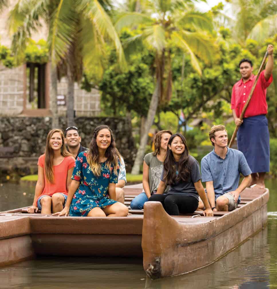 Guests float in a double hulled canoe at the Polynesian Cultural Center on Oahu. 