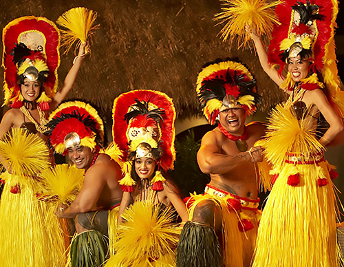 Performers pose in grass skirts and traditional luau headdresses.