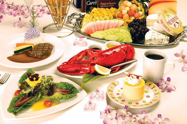 A 5-course meal is plated with steak, lobster, salad, cheese, fruit and dessert. 