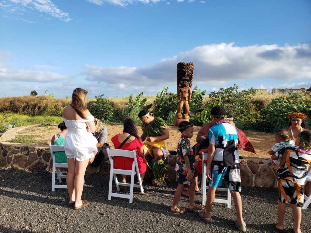 Children lined up for temporary Polynesian tattoos at the Mauka Warriors Luau, one of the top authentic luaus on Oahu.