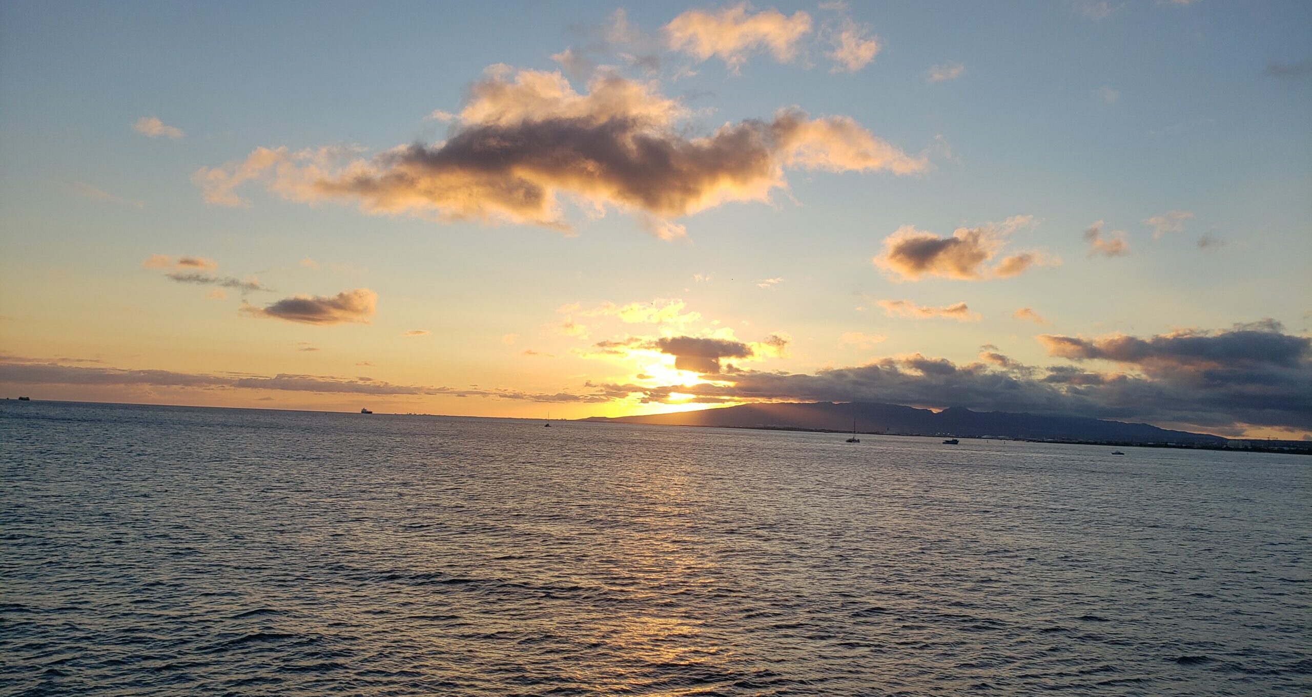 The sun sets over Waikiki Bay, taken from the deck of the Star of Honolulu dinner cruise