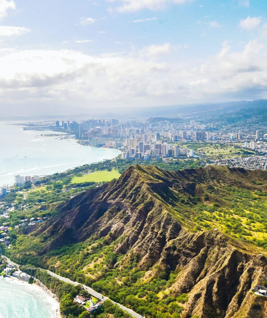 Aerial view of Diamond Head Crater with Waikiki Beach and Honolulu in the background. 