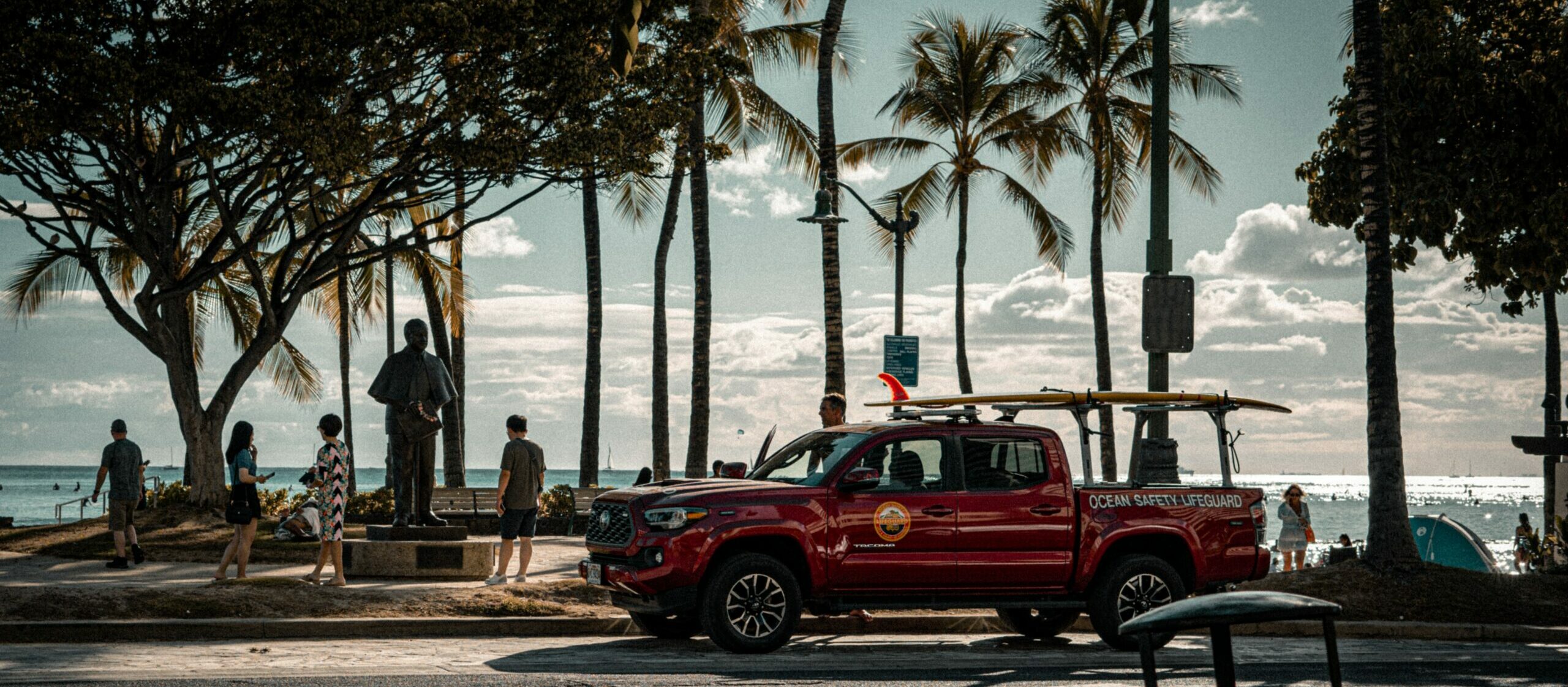 Lifeguard truck parked in front of a Waikiki beach.